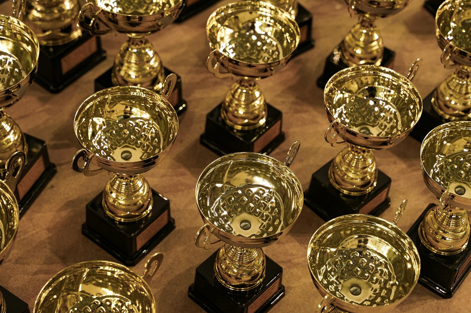 Rows of gold award trophies on a table