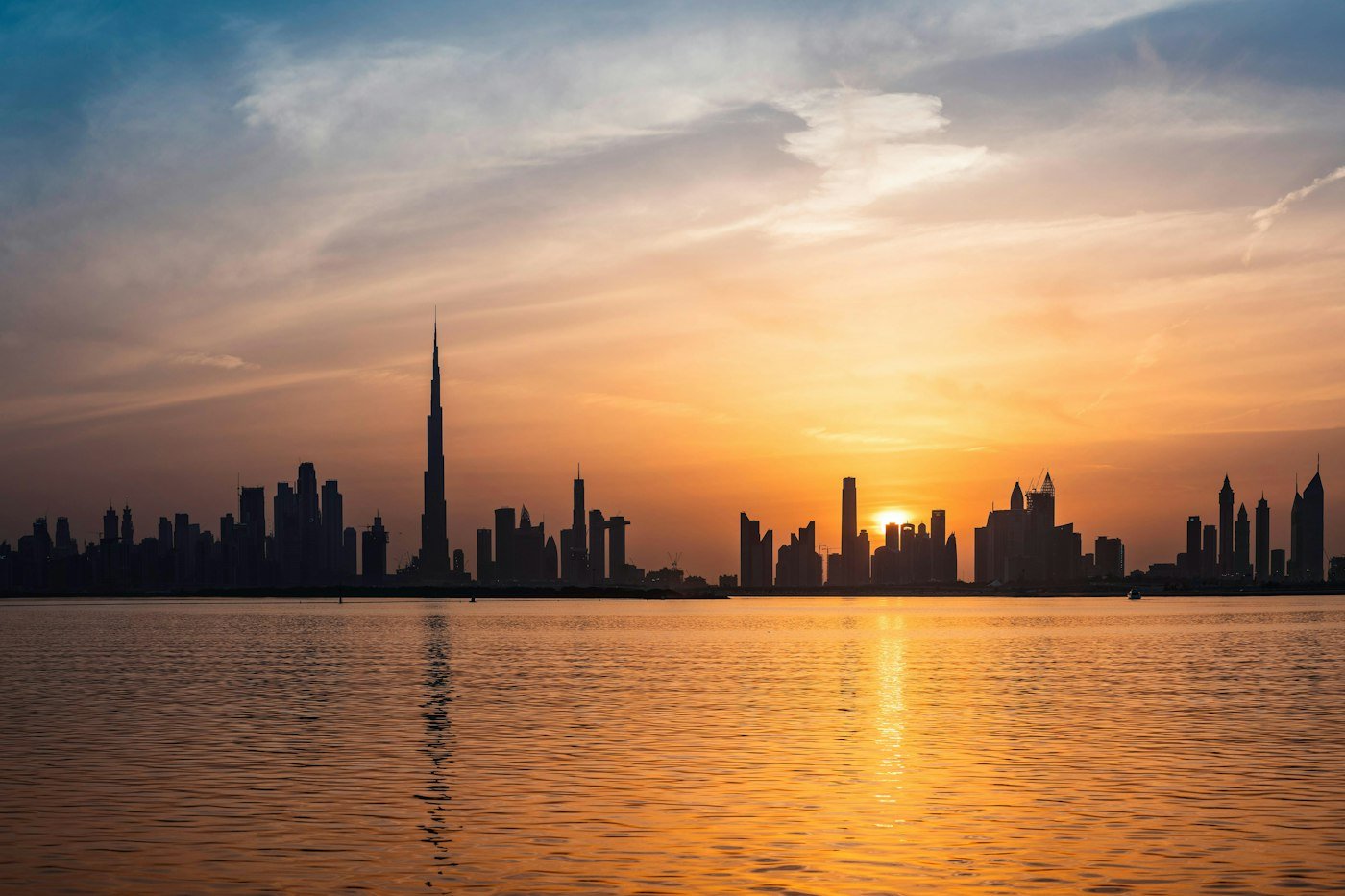 Dubai skyline at sunset seen across the water